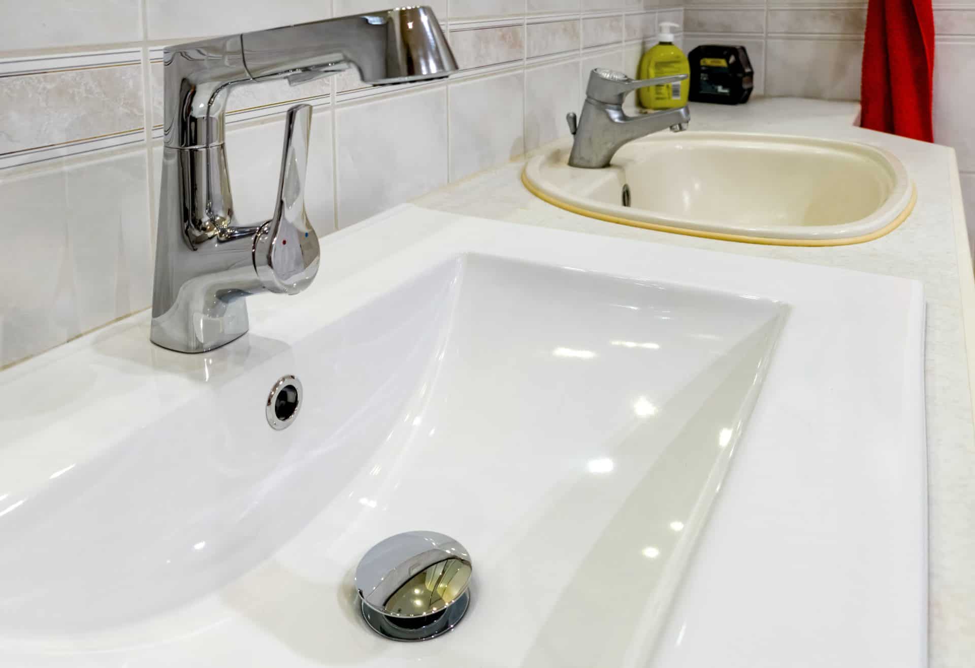 Bathroom renovation with new sink showing comparison of old and new